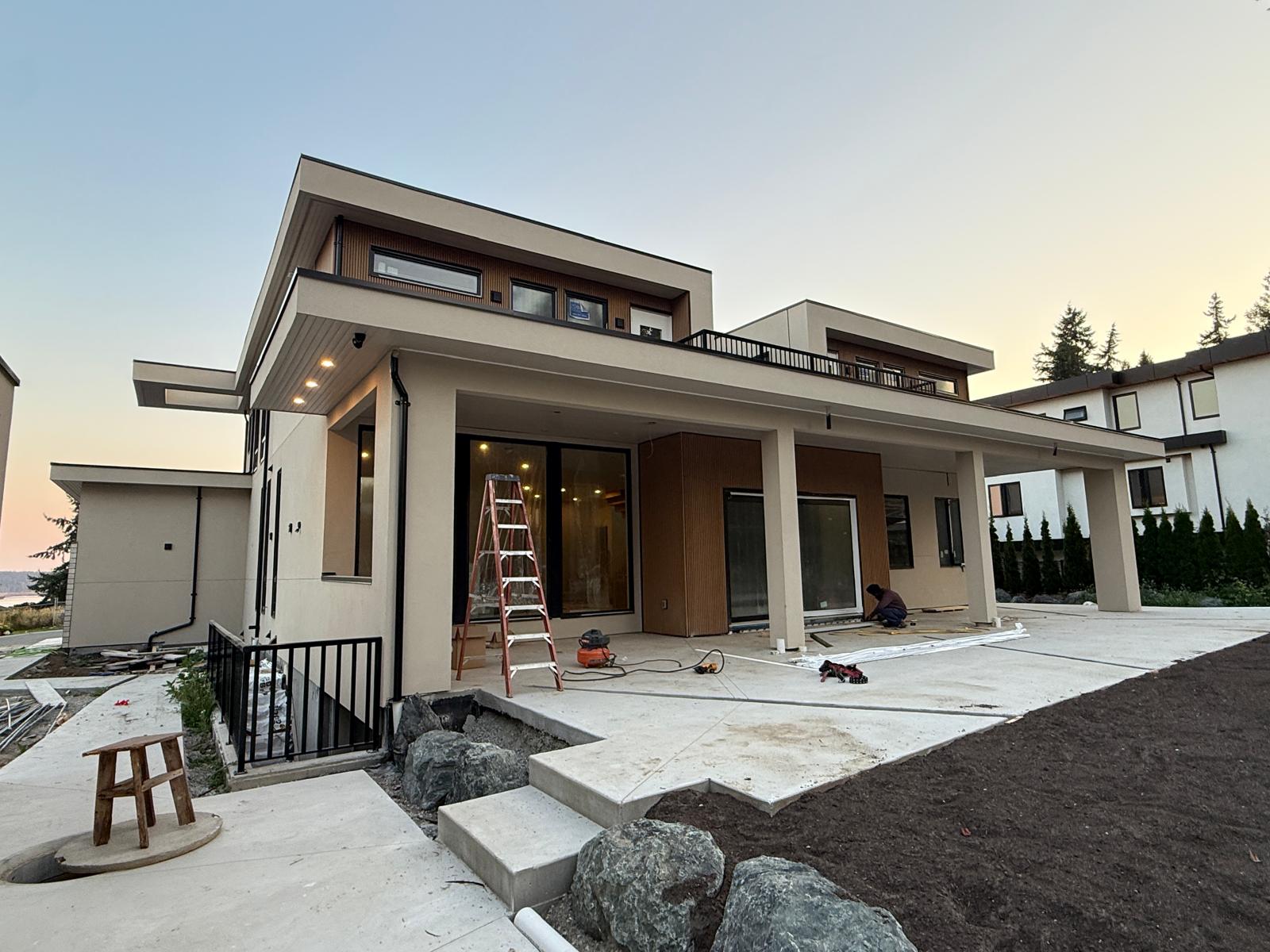 Luxury home entrance with living wall and cedar soffit by SMG Exteriors